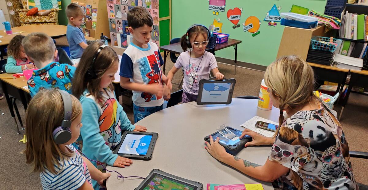 Students in classroom with iPad