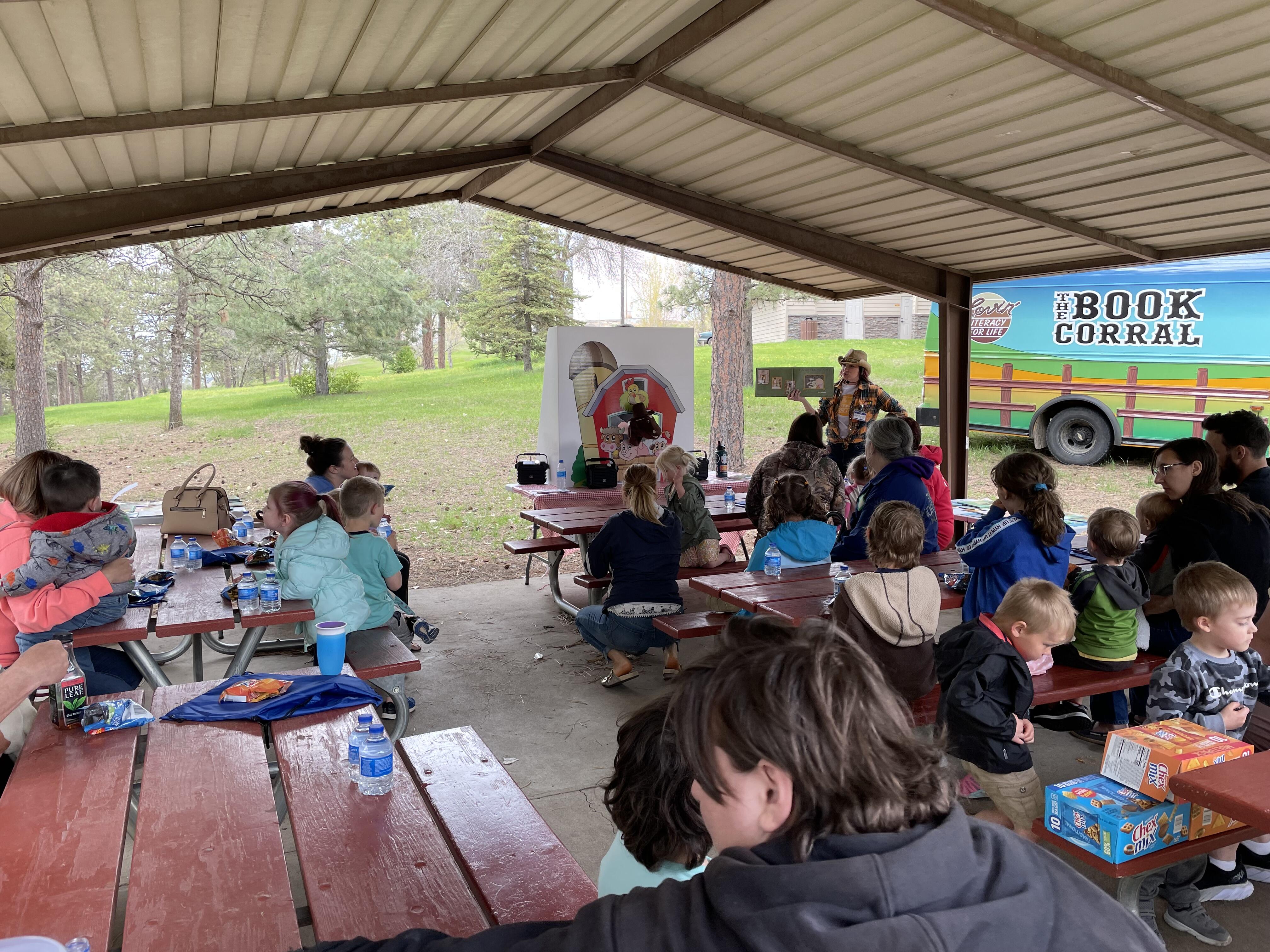 Students outside listening to story time during a reading rodeo
