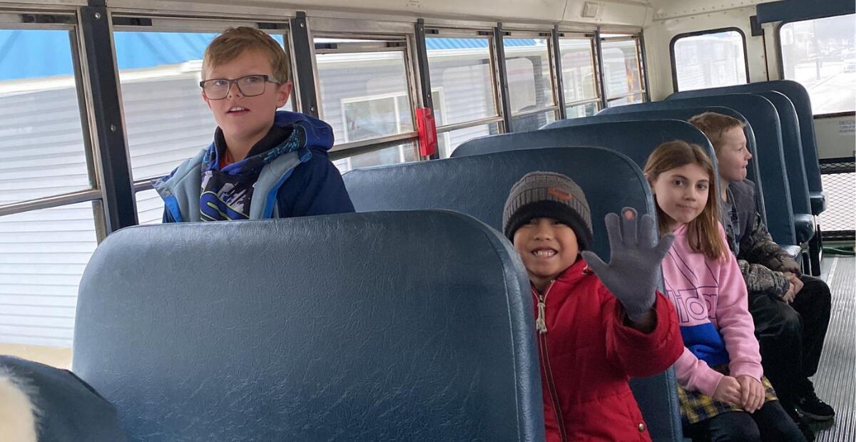 Elementary students riding the bus