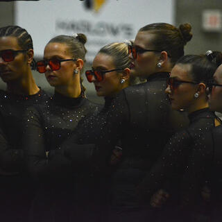 Dance team posing with sunglasees